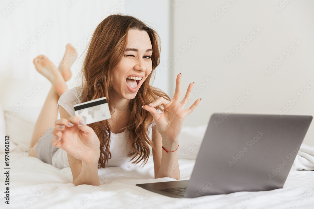 Portrait of a satisfied young woman showing credit card Portrait of a satisfied young woman showing credit card