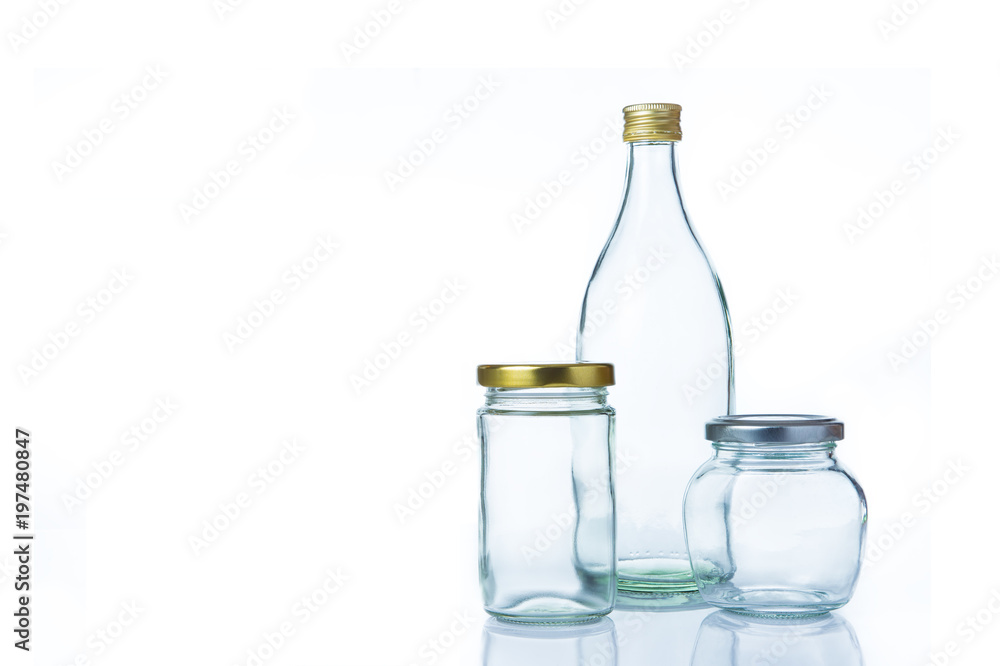Clear glass bottles in various sizes and shapes with lids on white background Clear glass bottles in various sizes and shapes with lids on white background