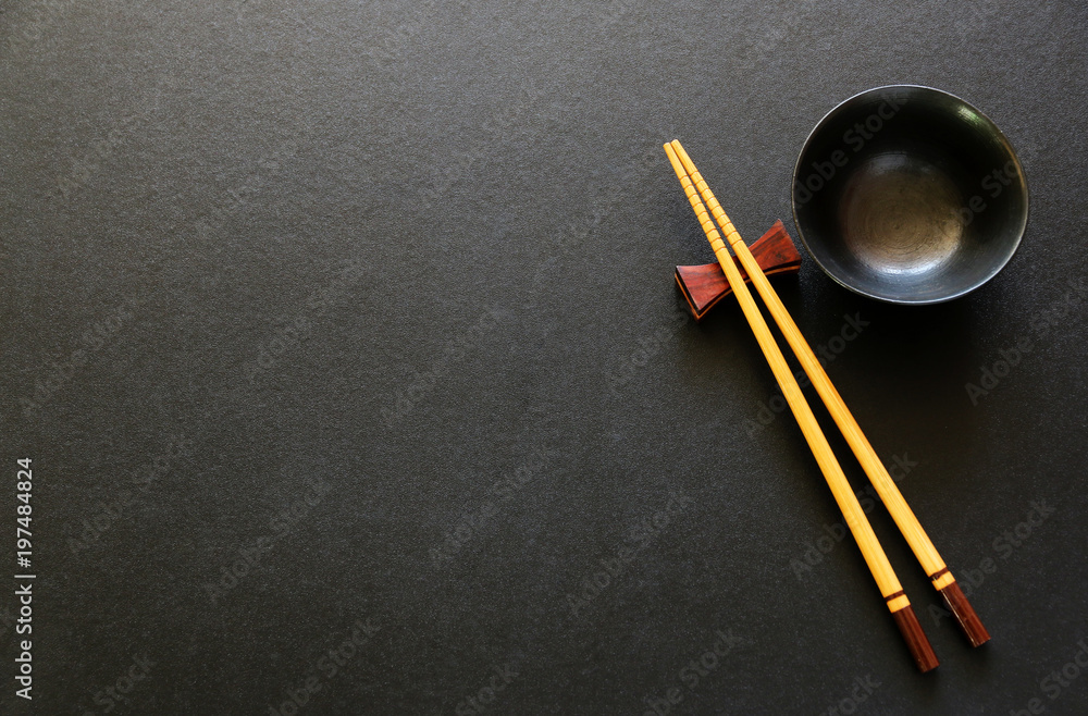 mock up Wooden Chopsticks and Ceramic bowl for sushi on black background.Copy space,Flat lay mock up Wooden Chopsticks and Ceramic bowl for sushi on black background.Copy space,Flat lay