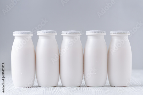 five bottles of drink yogurt on gray background