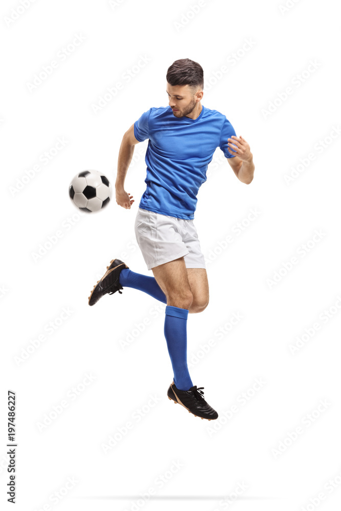 Soccer player performing a trick with a football in mid-air Soccer player performing a trick with a football in mid-air