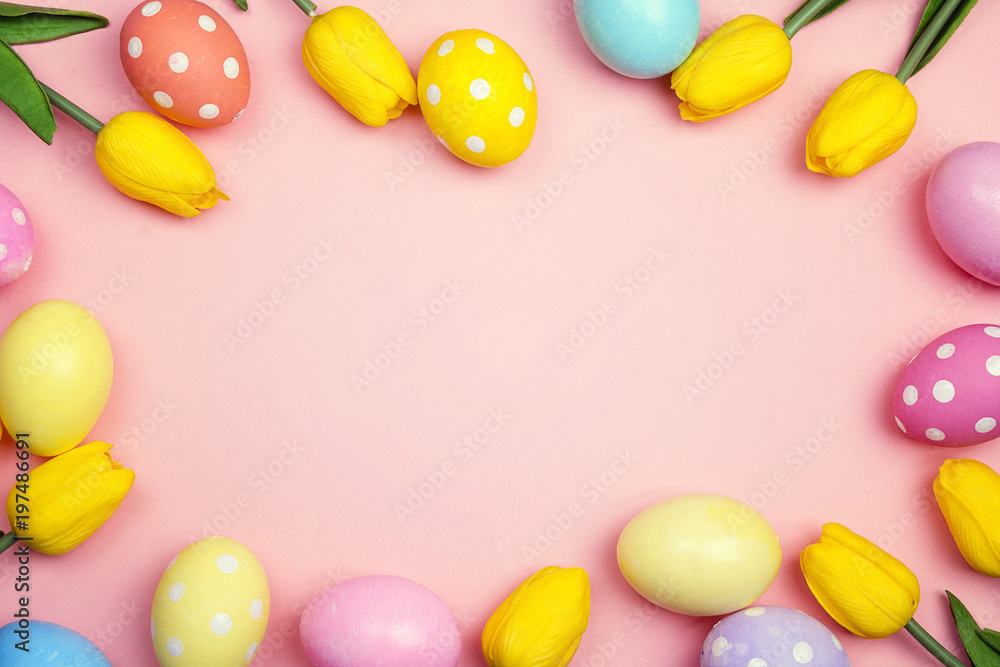 Easter frame with eggs and yellow tulips on pink background. Space for text.
