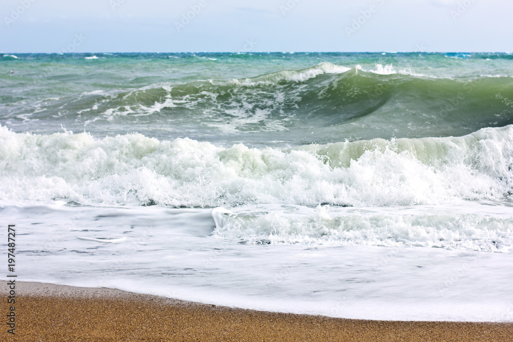 Stormy sea and blue sky, white sea foam on a yellow sandy beach. Stormy sea and blue sky, white sea foam on a yellow sandy beach.