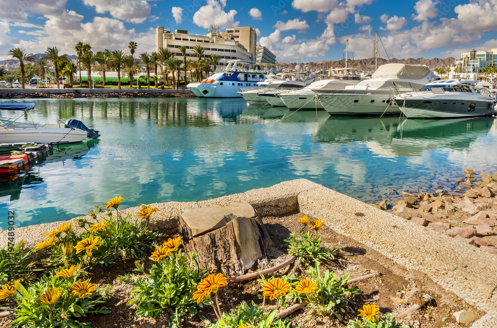 Central marine and promenade with pleasure boats,  surrounding hotels, market and shopping places in Eilat - famous resort and recreational city in Israel and Middle East
