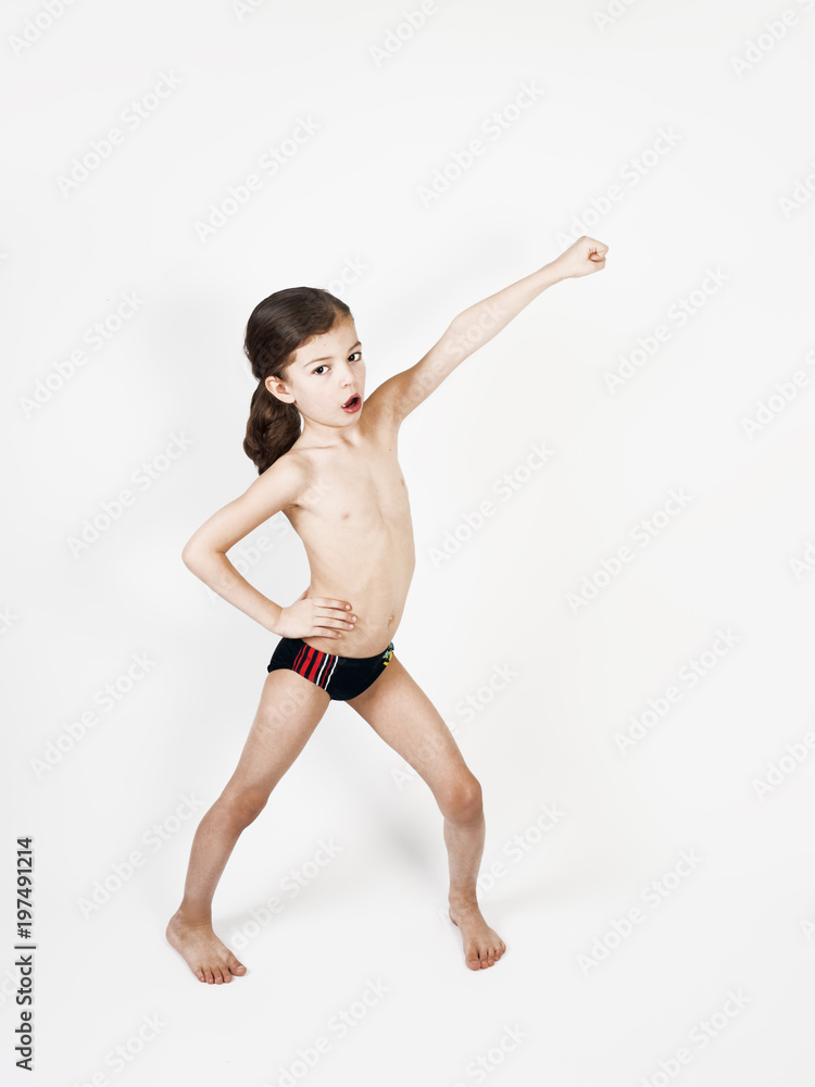 Superhero kid against a light background. Sport power concept Superhero kid against a light background. Sport power concept
