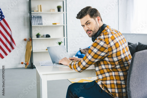 Freelancer working by laptop at home office