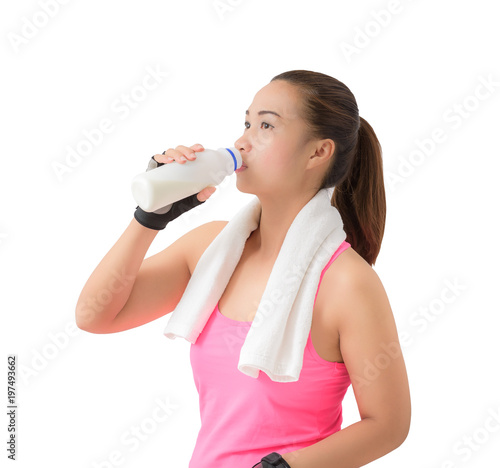 Fitness woman happy smiling holding milk bottle and drinking milk