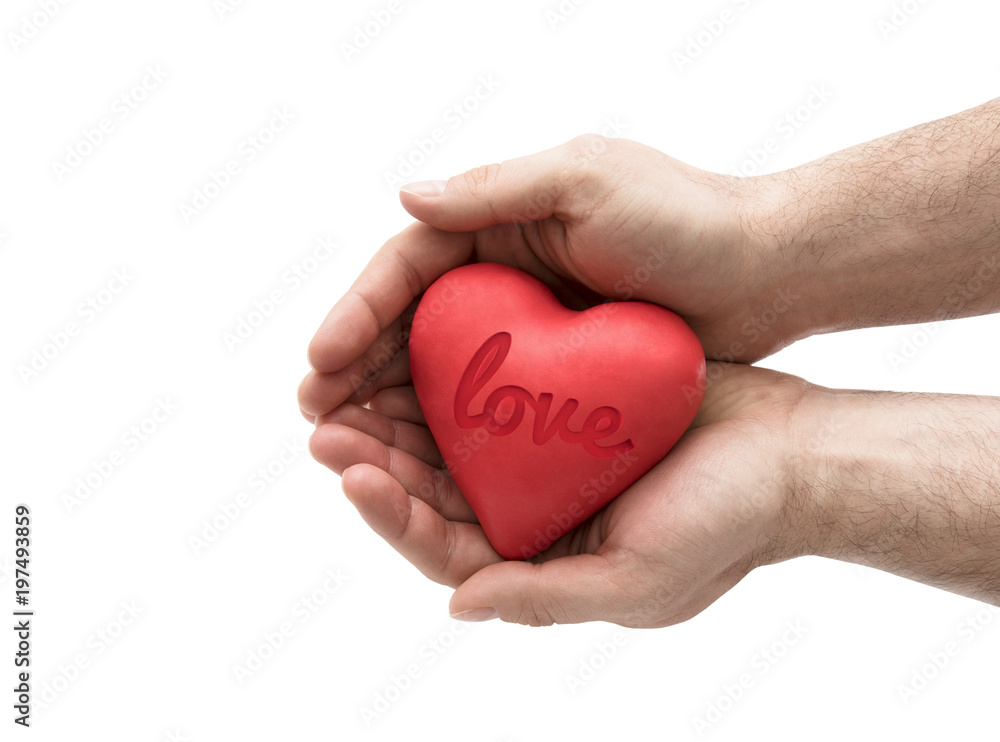 Red heart with imprinted love word in man's hands. Red heart with imprinted love word in man's hands.