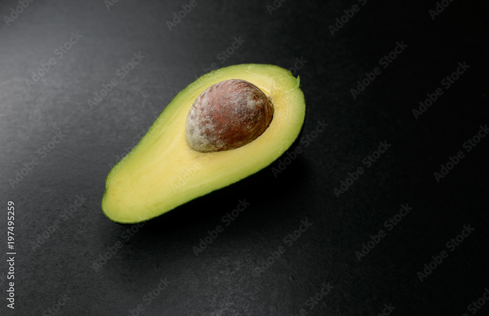 Avocado on dark background. Selective focus and shallow depth of field.
