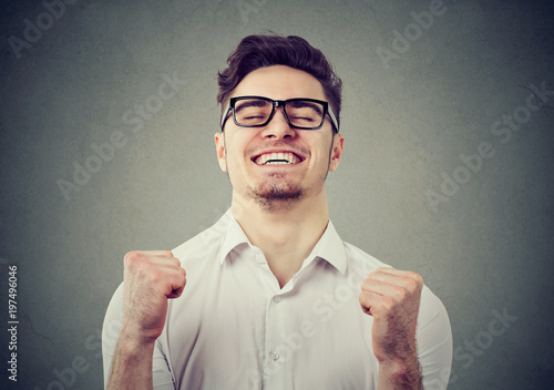 Excited man feeling relief with win photo
