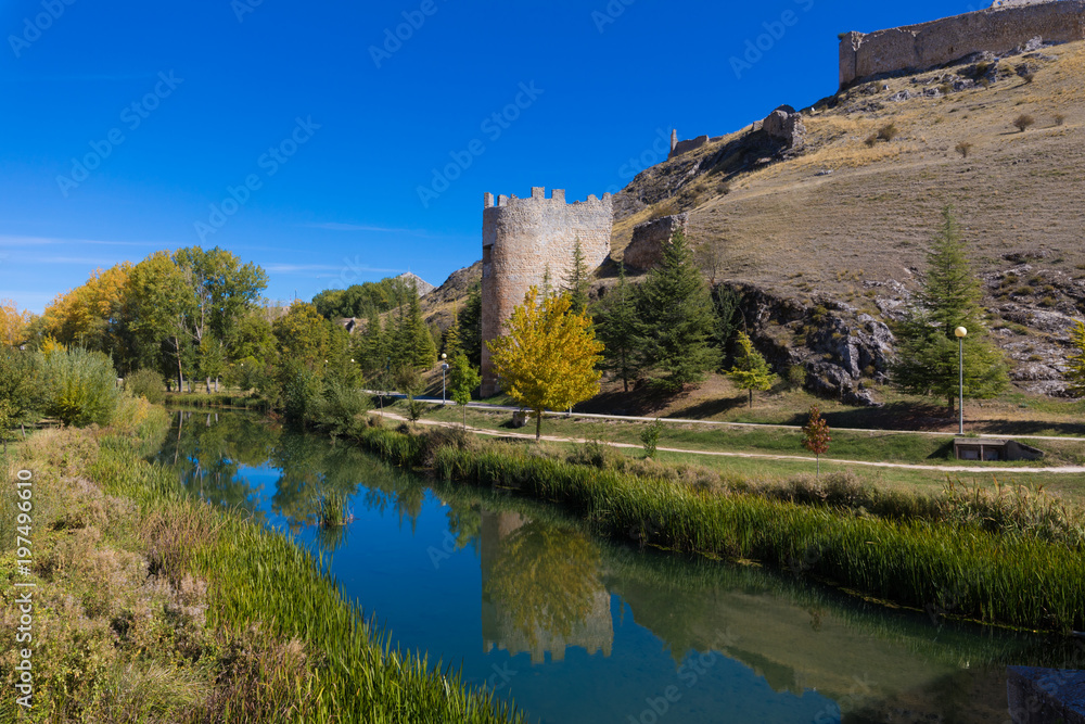 beautiful scenery with medieval tower reflected on water of Ucero river, landmark and public monument from tenth century, in Burgo de Osma, Soria, Spain, Europe, 
