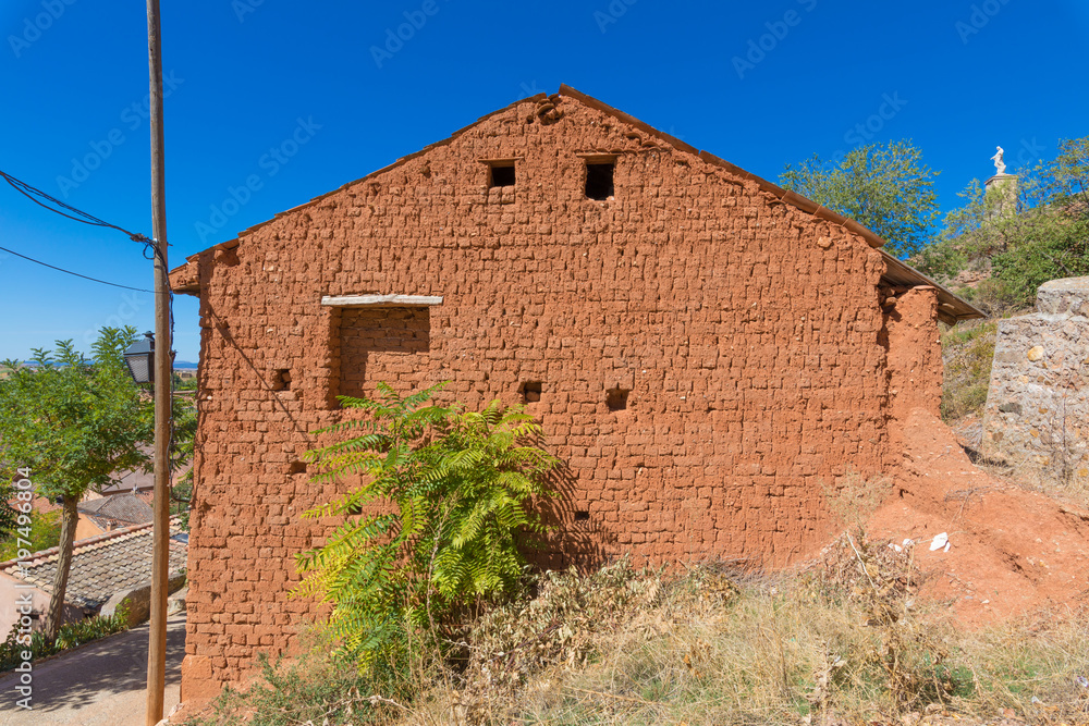 wall side of house built with adobe bricks, roof open gable, in nature, in old town of Ayllon village, Segovia, Spain, Europe
