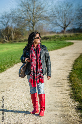 Lady in the mid 40s countryside in red boots © C@rsten