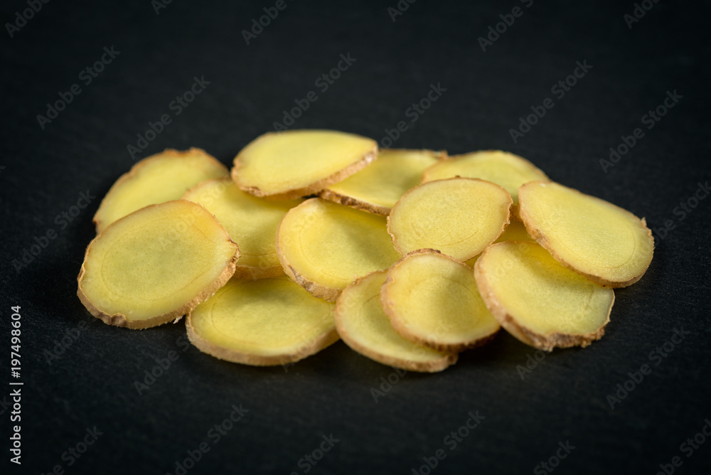 sliced ginger on a stone background sliced ginger on a stone background
