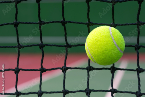 Tennis ball hitting to net on blur tennis court background © WK Stock Photo 