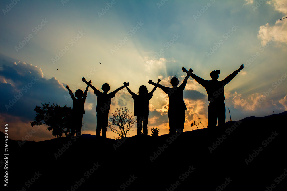 Silhouette group children playing on mountain at sunset time. Silhouette group children playing on mountain at sunset time.