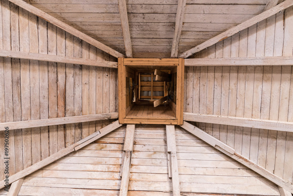 Naklejka premium Old wooden roof, rafters and chimney.