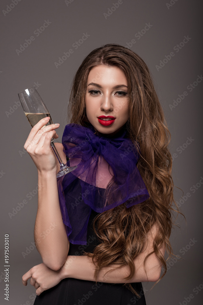 beautiful girl in purple scarf posing with champagne glass, isolated on grey beautiful girl in purple scarf posing with champagne glass, isolated on grey