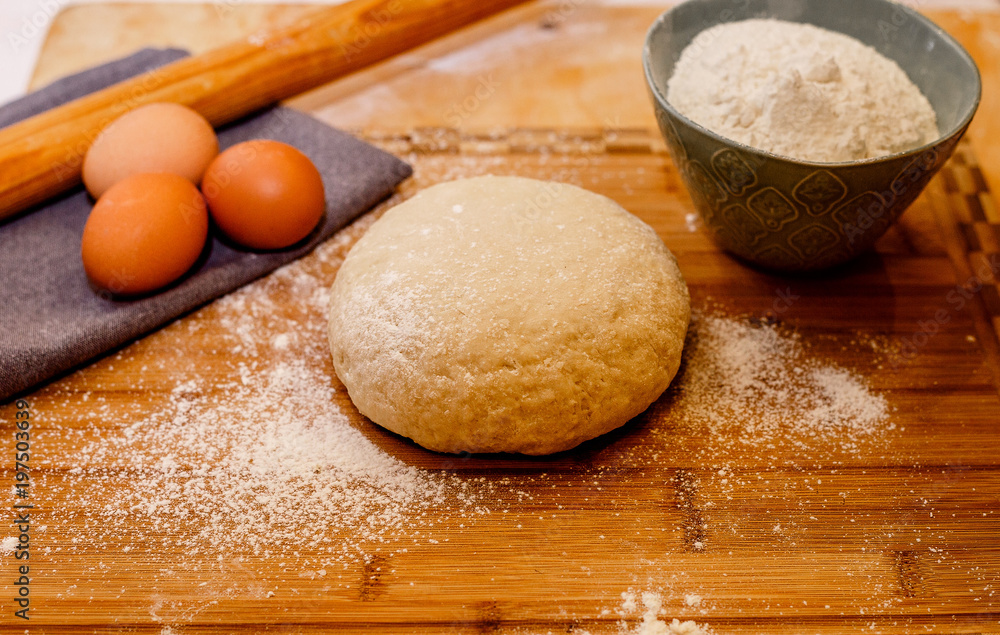 Ingredients for dough on wooden table. Close up Ingredients for dough on wooden table. Close up