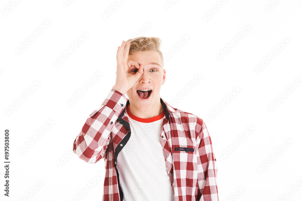 Portrait of a cheerful schoolboy showing ok gesture Portrait of a cheerful schoolboy showing ok gesture