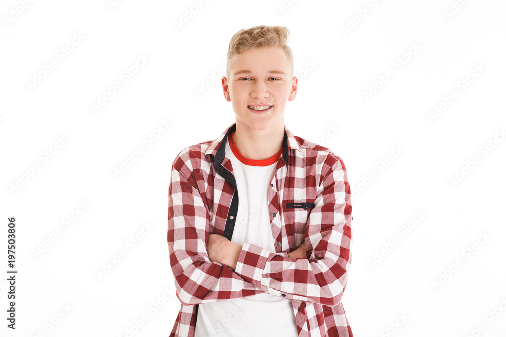 Portrait of a cheerful schoolboy standing with arms Portrait of a cheerful schoolboy standing with arms