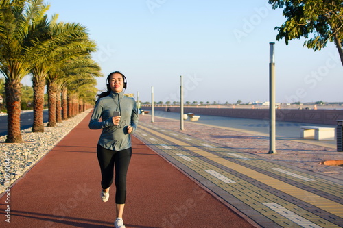 Girl jogging on the running track, active lifestyle