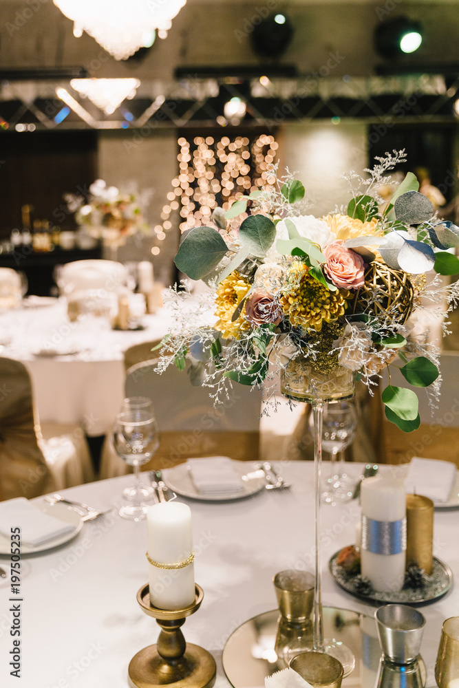 Candle and flower decoration for an event party or wedding on the table in restaurant. Candle and flower decoration for an event party or wedding on the table in restaurant.