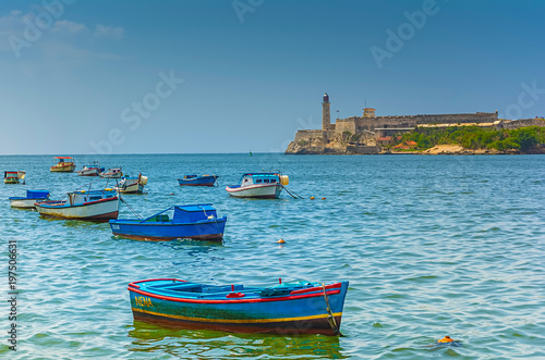 Local fishing boats in Havana, Cuba with El Morro castle in the background © Christian Schmidt 