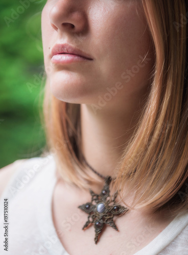 Portrait of beautiful woman with necklace on her neck