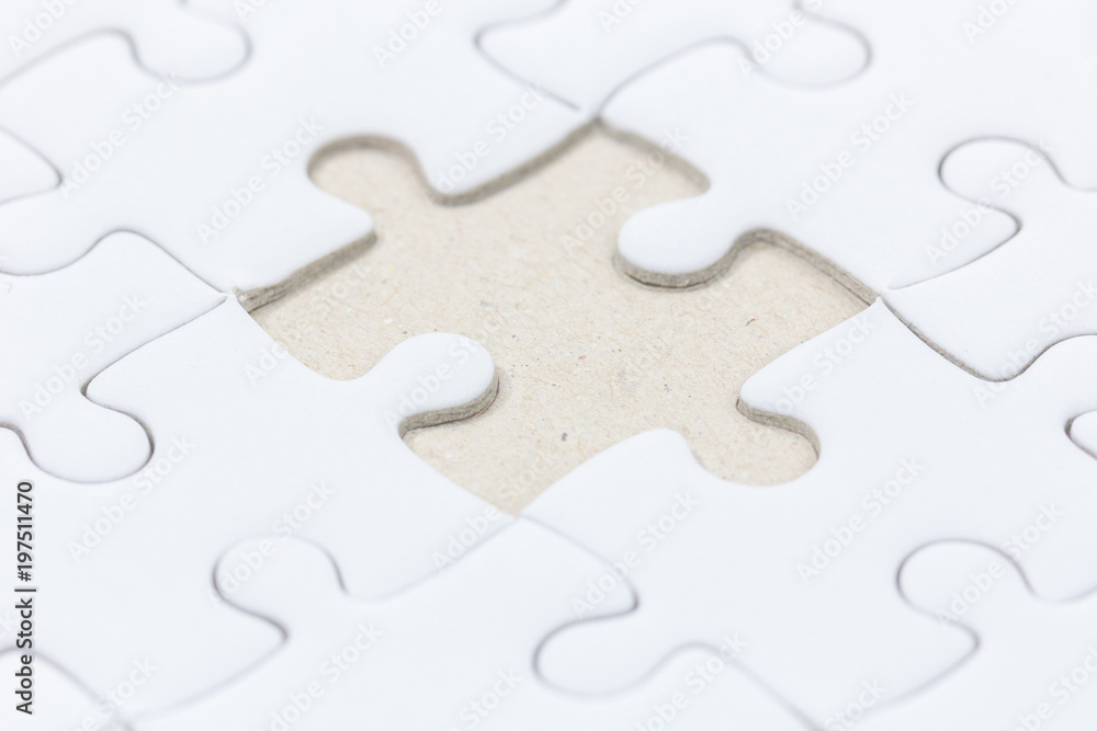 close up of White jigsaw puzzle with missed piece close up of White jigsaw puzzle with missed piece