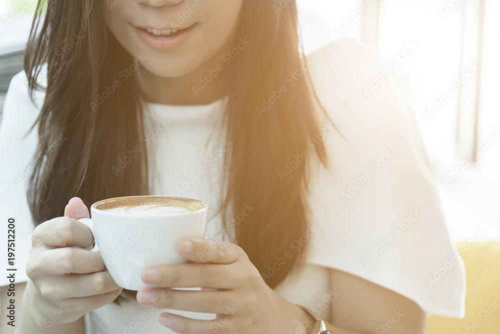 A coffee cup and beautiful asian businesswoman in the morning with working and relaxing time. A coffee cup and beautiful asian businesswoman in the morning with working and relaxing time.