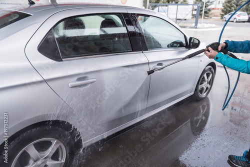 Car wash. High-pressure water and foam cleaning, aluminum wheels washing, winter maintenance