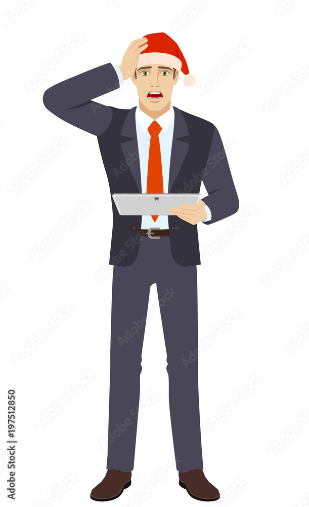 Businessman in Santa hat holding digital tablet PC and grabbed his head Businessman in Santa hat holding digital tablet PC and grabbed his head