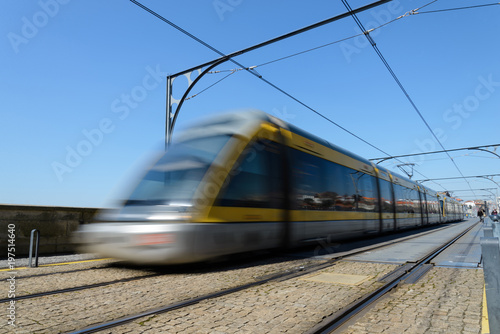 Electric train moving blurred near the station. Is an important means of transportation. This image can be used to represent a fast transport.