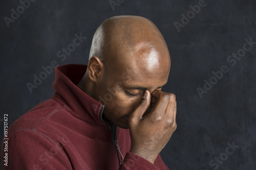 Portrait of a black man looking sad, depressed © Burlingham