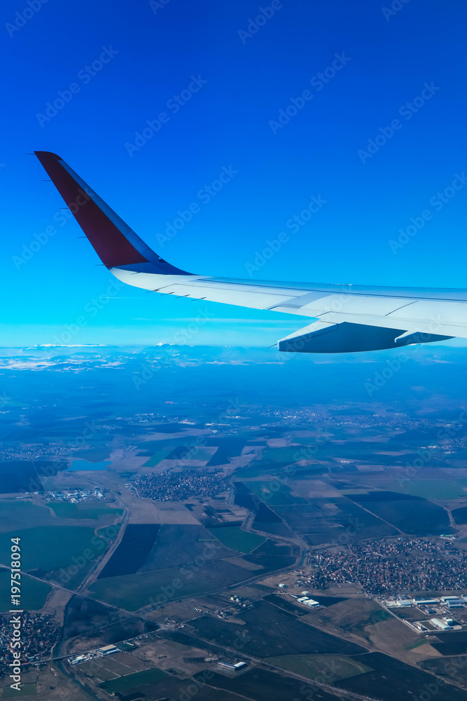 View from the airplane window on the wing and clouds in the sky. View from the airplane window on the wing and clouds in the sky.