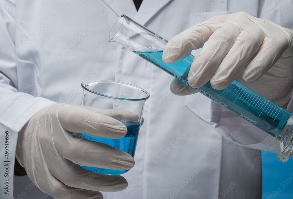 chemical lab, hand with graduated test tubes
chemical lab, hand with graduated test tubes