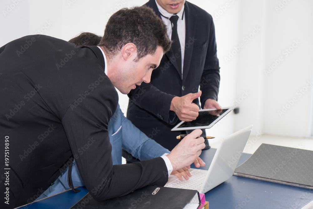 Business men pointing at report in laptop to discuss about strategy. Brainstorming, Concept for Work, Meeting, Presentation, Coaching Business men pointing at report in laptop to discuss about strategy. Brainstorming, Concept for Work, Meeting, Presentation, Coaching