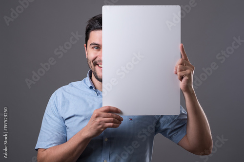 Youn man holds board