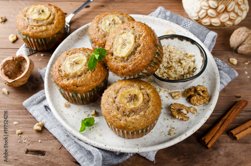 Banana muffins with cinnamon on wooden background