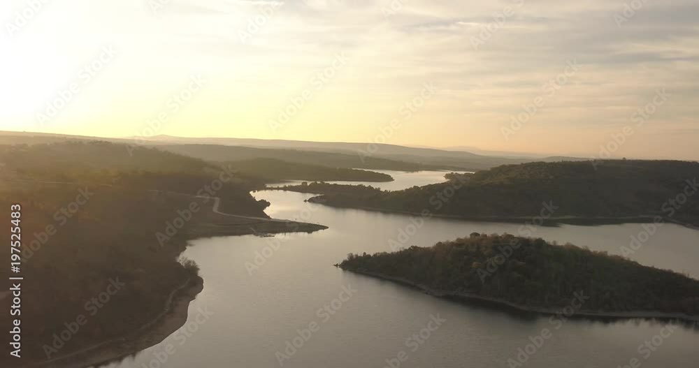 Flying over magical mystic lake sunrise near a misty forest pivot aerialdown shot Flying over magical mystic lake sunrise near a misty forest pivot aerialdown shot
