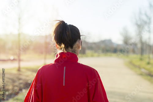Active and sporty woman runner in autumn nature