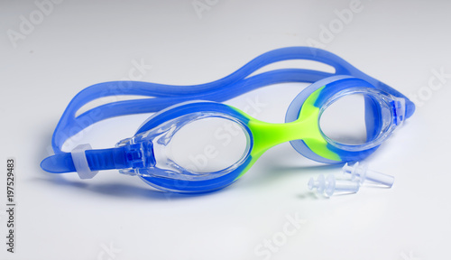 Blue glasses for swim on white background, ear plugs.