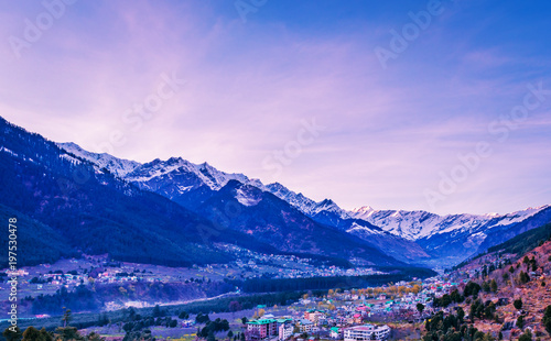 View of Manali City and snow covered Himalayas mountains in India from the top of a mountain 
