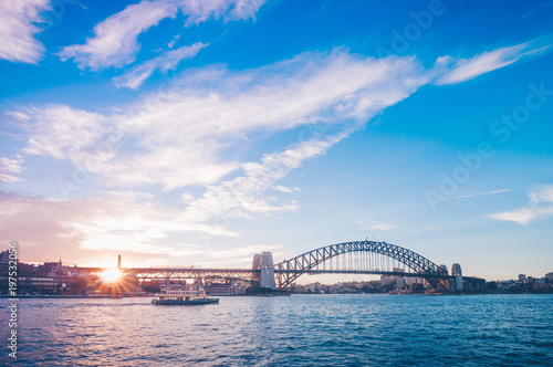 Fototapeta Naklejka Na Ścianę i Meble -  Famous sunset over Sydney Harbour Bridge. Stunning view of the waterfront near the Opera house.