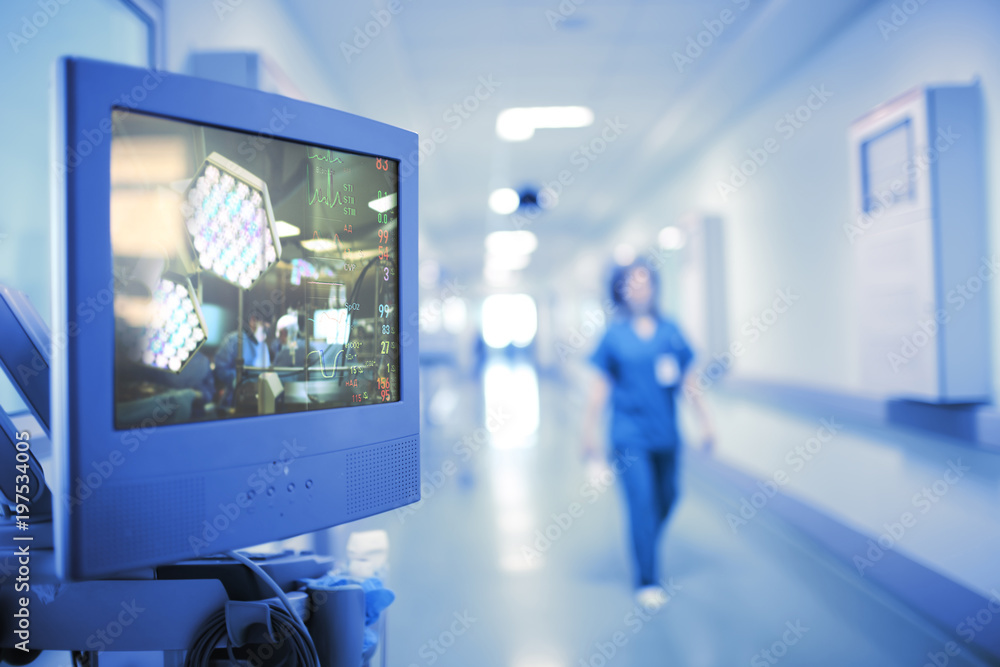 Naklejka premium Translation of the operation on the monitor in the hospital corridor, concept of modern technologies in the health care industry