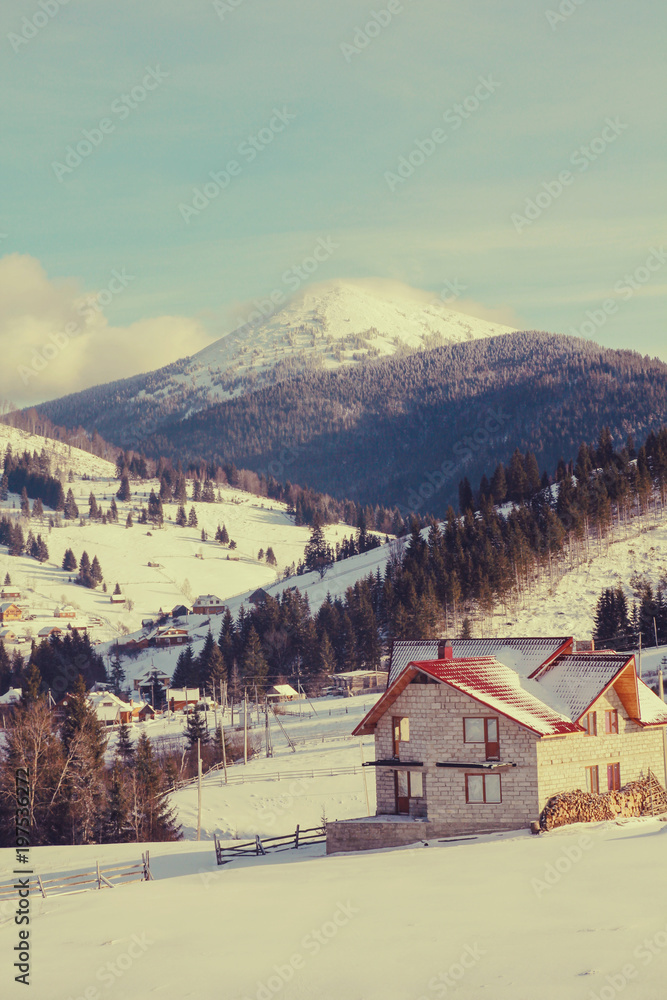 Mountain house covered with fresh snow in the Carpathian mountains