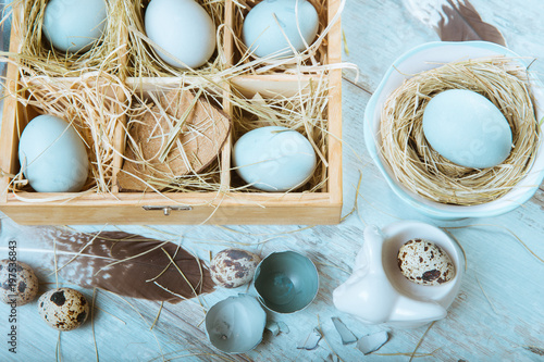 Easter background with Easter eggs and spring flowers. Top view with copy space photo