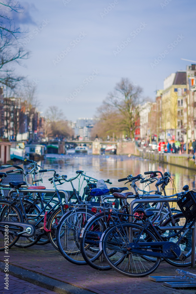 Outdoor view of bycicles parked at the bridge in Amsterdam