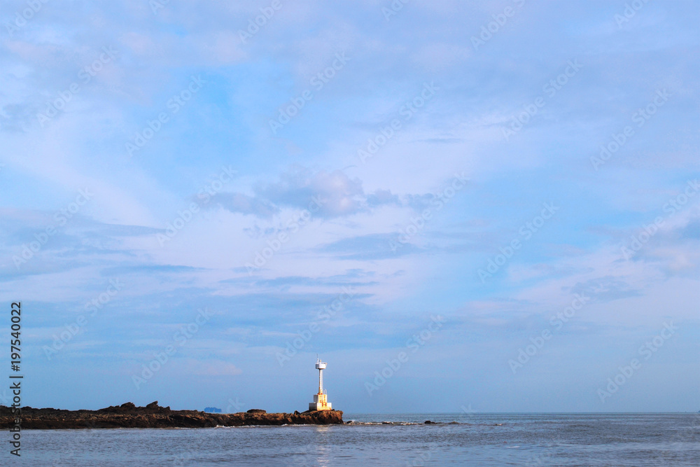 Seascape with a lighthouse on the horizon. Beautiful blue sky. Seascape with a lighthouse on the horizon. Beautiful blue sky.